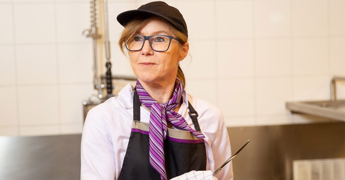 Hospitality worker wearing non-slip kitchen shoes during her shift