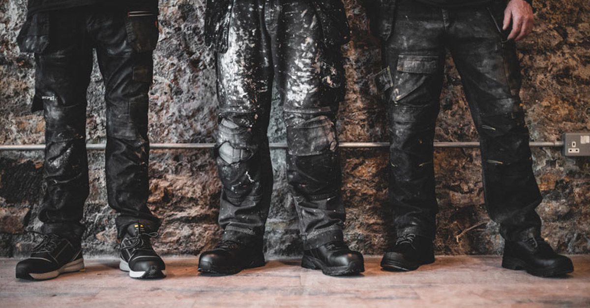 Construction workers standing on the job wearing black, water-resistant work boots