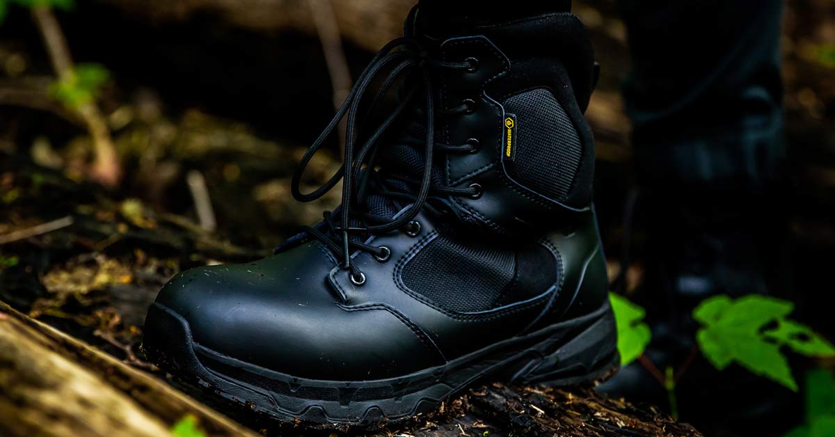 Worker wearing black sturdy, safety boots while on the job