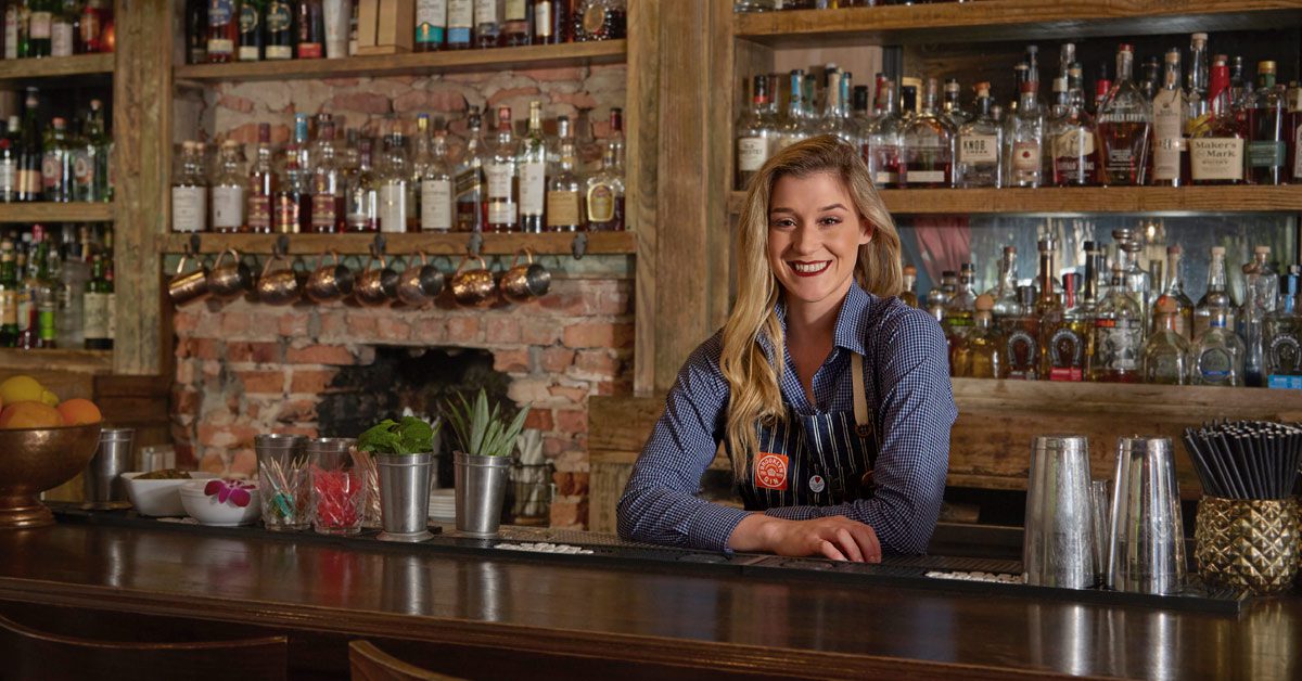 Bartender behind counter in pub