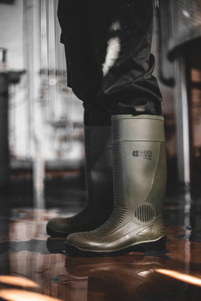 Worker wearing water-resistant work boots and moving across different surfaces