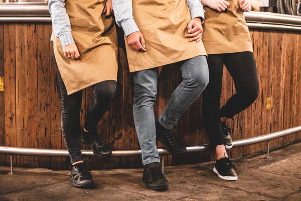 Waiting staff wearing various Shoes For Crews casual shoe styles to prevent trip hazards in the workplace