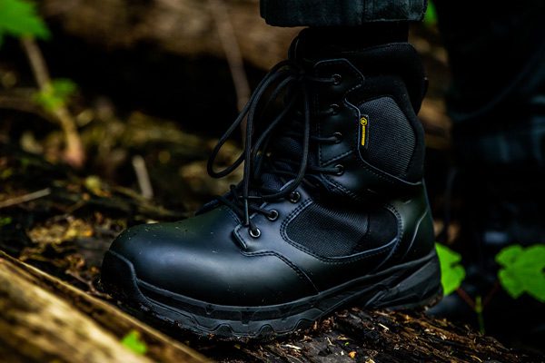 Army officer wearing high ankle Defense military boot while trekking
