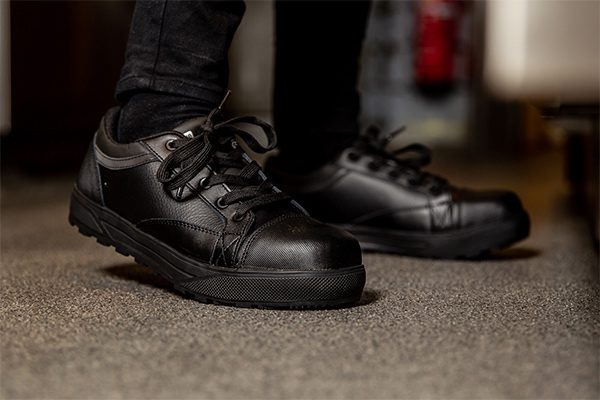 Worker wearing Shoes For Crews safety trainer Fergus with slip-resistant outsole