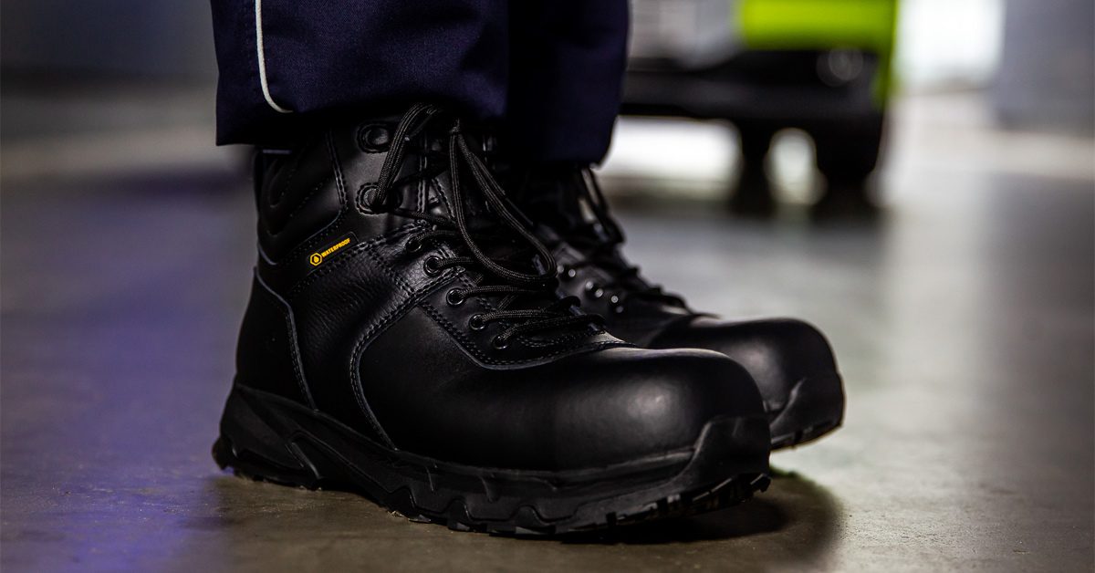 Manufacturing worker wearing safety shoes in a stone building with resin floors