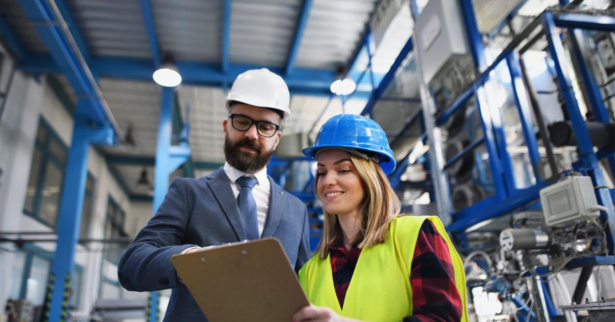 An engineer and manager performing a routine safety check at a warehouse