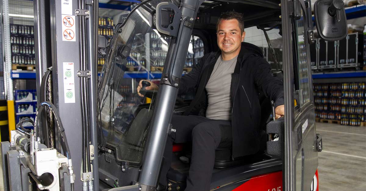 Warehouse worker sitting in forklift wearing Shoes For Crews Engineer IV CT boots