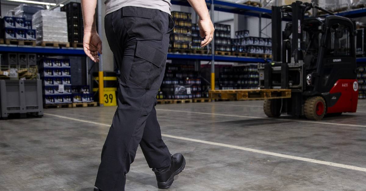 Warehouse worker walking to a forklift with slip-resistant shoes